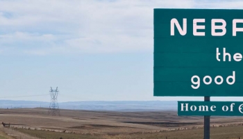 The Nebraska skyline and a view of the Welcome to Nebraska road sign